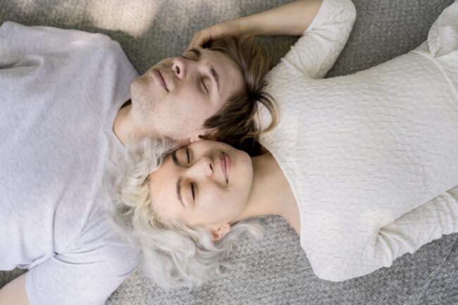 top-view-cute-couple-relaxing-outdoors-blanket