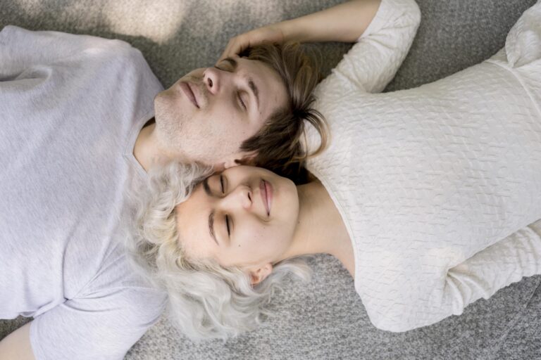 top-view-cute-couple-relaxing-outdoors-blanket